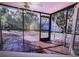 Screened in patio with tile floor and view of the backyard at 910 Robinson N Dr, St Petersburg, FL 33710