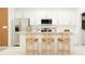 Modern kitchen with white cabinets, stainless steel appliances, and counter seating at 9359 Raised Tulip Ln, Land O Lakes, FL 34637