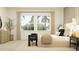 Bright bedroom featuring a large window, neutral tones, and stylish furnishings at 9558 Runaway Breeze Dr, Land O Lakes, FL 34637