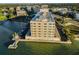 Aerial view of a waterfront building with private docks on beautiful blue water at 100 Bluff View Dr # 514C, Belleair Bluffs, FL 33770