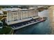 Aerial view of a waterfront condo building featuring on-site parking and waterfront access with bridge view at 100 Bluff View Dr # 514C, Belleair Bluffs, FL 33770