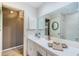 Cozy bathroom with floral wallpaper, ample countertop space, and a large mirror to add depth at 100 Bluff View Dr # 514C, Belleair Bluffs, FL 33770