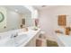 Bathroom with a large mirror, counter space, and bathtub at 100 Bluff View Dr # 514C, Belleair Bluffs, FL 33770