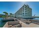 Beautiful waterfront condo building with a private dock and seating area overlooking the water at 100 Bluff View Dr # 514C, Belleair Bluffs, FL 33770