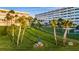 Well-maintained grounds feature lush green grass, mature palm trees, and inviting outdoor seating for relaxation at 100 Bluff View Dr # 514C, Belleair Bluffs, FL 33770