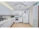 Cozy kitchen features white cabinets, appliances, ample counter space, and a ceiling fan at 100 Bluff View Dr # 514C, Belleair Bluffs, FL 33770