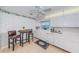 Compact eat-in kitchen features all-white appliances, stylish flooring, and breakfast table at 100 Bluff View Dr # 514C, Belleair Bluffs, FL 33770