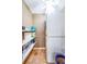Convenient laundry area with stacked washer/dryer units and open shelving for storage at 100 Bluff View Dr # 514C, Belleair Bluffs, FL 33770