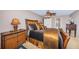 Comfortable main bedroom suite with a ceiling fan and side table with drawers for storage at 100 Bluff View Dr # 514C, Belleair Bluffs, FL 33770