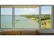 Breathtaking water view from the living room window showcasing a lush green landscape at 100 Bluff View Dr # 514C, Belleair Bluffs, FL 33770