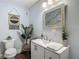 Stylishly decorated bathroom with modern vanity, decorative mirror, and unique wall art at 1014 Sylvia Ln, Tampa, FL 33613