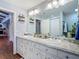Bright bathroom featuring a double sink vanity with granite counters, stylish decor, and ample space at 1014 Sylvia Ln, Tampa, FL 33613
