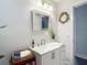 Bright bathroom featuring a modern vanity with decorative mirror and updated fixtures at 1014 Sylvia Ln, Tampa, FL 33613