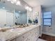 Bright bathroom with double sink vanity, granite counters, and stylish decor at 1014 Sylvia Ln, Tampa, FL 33613
