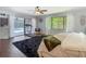 Bedroom featuring sliding glass doors to a patio, a ceiling fan, and a treadmill at 1014 Sylvia Ln, Tampa, FL 33613