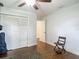 A bedroom offering a large closet, neutral paint, a ceiling fan, wood-look floors and a window bringing in natural light at 1014 Sylvia Ln, Tampa, FL 33613