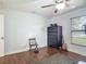 A bedroom showcasing wood-look floors, chest of drawers, neutral paint, and a window bringing in natural light at 1014 Sylvia Ln, Tampa, FL 33613