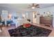 Well-lit bedroom with hardwood floors, a large area rug, and a view of the adjoining bathroom at 1014 Sylvia Ln, Tampa, FL 33613