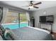 Inviting bedroom featuring a view of the sparkling pool, complemented by cozy furnishings and ample natural light at 1014 Sylvia Ln, Tampa, FL 33613