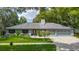 Charming single-story home with well-manicured lawn, mature trees and a two car garage at 1014 Sylvia Ln, Tampa, FL 33613