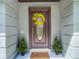 Inviting front door with decorative wreath and side shrubbery, offering a warm welcome at 1014 Sylvia Ln, Tampa, FL 33613