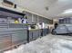 Organized garage features ample storage with rolling tool chests and cabinets, plus a covered vehicle at 1014 Sylvia Ln, Tampa, FL 33613