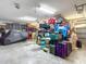 Spacious garage is filled with organized storage, including a covered vehicle, and cabinets along the wall at 1014 Sylvia Ln, Tampa, FL 33613