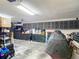 Well-organized garage provides ample storage space with cabinets and tool chests, featuring a covered vehicle at 1014 Sylvia Ln, Tampa, FL 33613