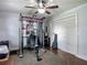 Bright home gym featuring state-of-the-art equipment, a ceiling fan, wood-look flooring and modern gray walls at 1014 Sylvia Ln, Tampa, FL 33613