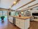 Bright kitchen with a wooden island, stainless steel appliances, and decorative wooden beams on the ceiling at 1014 Sylvia Ln, Tampa, FL 33613