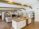 Open concept kitchen features an island with seating that transitions into the adjacent living room and beyond at 1014 Sylvia Ln, Tampa, FL 33613