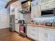 Bright and modern kitchen with custom white cabinetry, stainless appliances, and mosaic tile backsplash at 1014 Sylvia Ln, Tampa, FL 33613