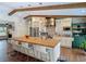Modern kitchen with wooden beams, stainless steel appliances, and island with bar seating at 1014 Sylvia Ln, Tampa, FL 33613