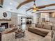 Spacious living area featuring a cozy fireplace, wood beam ceilings, and an open connection to the modern kitchen at 1014 Sylvia Ln, Tampa, FL 33613