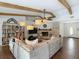 Stylish living area with a fireplace, wood beam ceilings, and an open flow to the entrance and kitchen at 1014 Sylvia Ln, Tampa, FL 33613