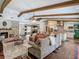 Inviting living space with wood beams, fireplace, and an open layout that seamlessly connects to the modern kitchen at 1014 Sylvia Ln, Tampa, FL 33613