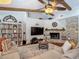 Comfortable living room highlighting built-in shelving, fireplace, wood beam ceilings, and a cozy seating area at 1014 Sylvia Ln, Tampa, FL 33613