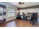 Bright office features hardwood floors, a ceiling fan and built-in storage for a comfortable, productive workspace at 1014 Sylvia Ln, Tampa, FL 33613