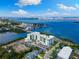 Beautiful aerial view featuring stunning bay views, lush landscaping, and contemporary architecture at 1020 Sunset Point Rd # 410, Clearwater, FL 33756