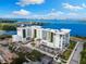 Wide-angle aerial view featuring beautiful bay views, and modern architecture with pristine landscaping at 1020 Sunset Point Rd # 410, Clearwater, FL 33756