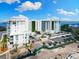Spacious, modern building featuring verdant green walls, ample parking, and beautiful landscaping at 1020 Sunset Point Rd # 410, Clearwater, FL 33756