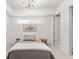 Comfortable bedroom with modern lighting and a large window at 1020 Sunset Point Rd # 410, Clearwater, FL 33756