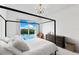 Bright bedroom with canopy bed and picturesque water view at 1020 Sunset Point Rd # 410, Clearwater, FL 33756