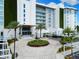 Stunning building entrance featuring meticulous landscaping, circle driveway, and grand architecture at 1020 Sunset Point Rd # 410, Clearwater, FL 33756
