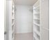 Spacious walk-in closet with ample shelving and neutral carpeting at 1020 Sunset Point Rd # 410, Clearwater, FL 33756