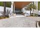 Inviting covered entrance showcases the building's grand design with palm trees and pavers leading to the front door at 1020 Sunset Point Rd # 410, Clearwater, FL 33756