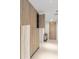 Hallway featuring wooden wall panels and tiled flooring at 1020 Sunset Point Rd # 410, Clearwater, FL 33756