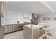 Modern kitchen boasts sleek cabinets, stainless steel appliances, a spacious island, and bar stool seating at 1020 Sunset Point Rd # 410, Clearwater, FL 33756