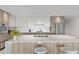 Modern kitchen with island, white countertop, seating, and stainless steel appliances at 1020 Sunset Point Rd # 410, Clearwater, FL 33756