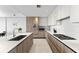 Stylish kitchen features modern cabinets, stainless steel appliances, a spacious island, and sleek countertops at 1020 Sunset Point Rd # 410, Clearwater, FL 33756